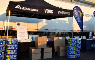 An expo tent with boxes and packs of water.